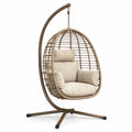 Chaise suspendue en résine tressée avec coussins beige et support en acier